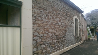 Dustless blasting of masonry walls after image