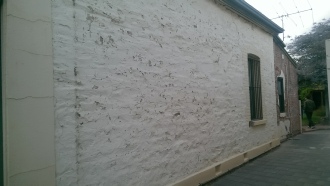 Dustless blasting of masonry walls before image